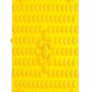 Macro detail shot of the raised massage nodules on a bright yellow acupressure foot mat