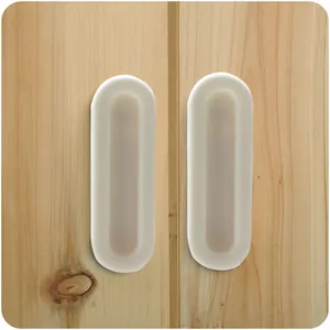 White self-adhesive handles for sliding doors and windows on wooden cabinet