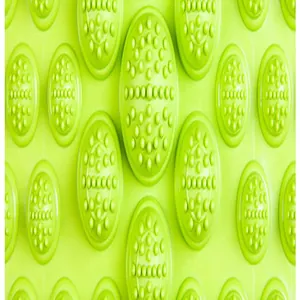 Macro detail of green acupressure mat showing circular textured massage nodes.