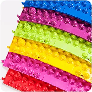 Vibrant and colorful acupressure foot massage mats stacked neatly on a white background
