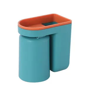Minimalist wall-mounted toothbrush holder set with teal rinse cup and orange organizer rim