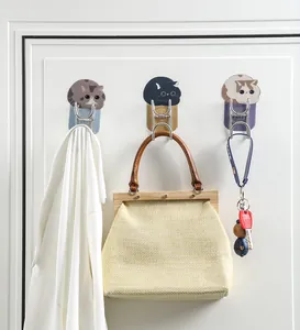 Three decorative cat-themed stainless steel wall hooks shown holding bags and keys
