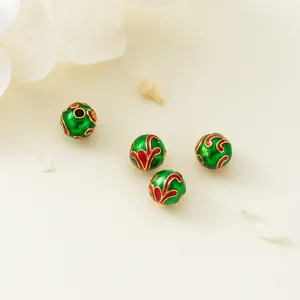 Close-up of 6mm green enamel 925 silver beads with red floral patterns for jewelry making