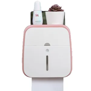 Pink wall-mounted bathroom tissue box holder with phone shelf and storage tray