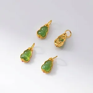 Detailed macro view of gold-plated silver Hetian jade gourd pendants with hollow back design