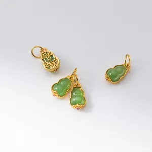 Detailed view of gold-plated filigree backing on green jade gourd charms for DIY jewelry