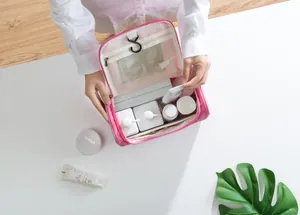 Detail view of pink travel toiletry bag showing internal compartments and hanging hook