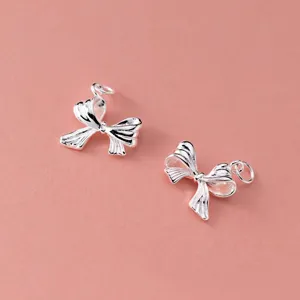 Close-up of polished 925 sterling silver bow pendants for DIY jewelry making