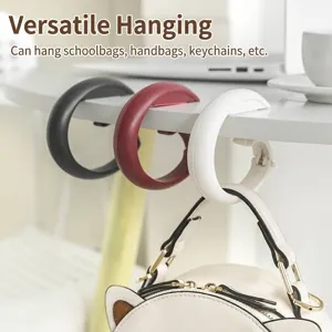 Portable non-punching desk side bag hooks in three colors for schoolbags and bags.