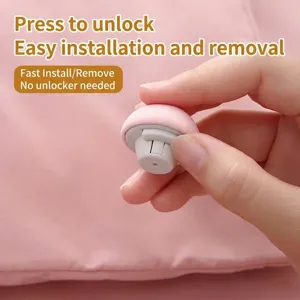 Pink mushroom-shaped quilt fixer featuring a needleless press-lock design for bedsheets