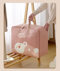 Detailed view of the large pink cartoon quilt storage bag featuring sturdy carry handles