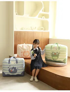 Asian child sitting with three colorful cartoon quilt storage bags in a cozy room setting