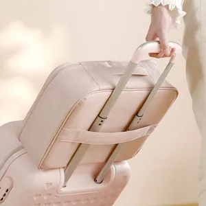 Pink travel document organizer bag conveniently mounted on a suitcase trolley handle