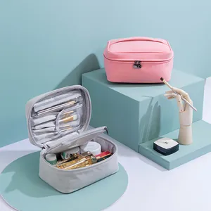 Detail of open grey makeup bag showing compartments for brushes and cosmetics