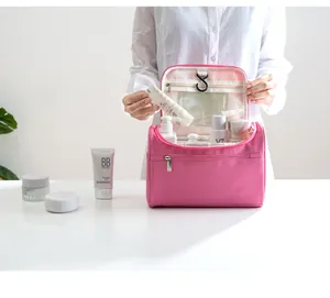 Close-up view of a pink hanging travel toiletry bag showing spacious internal compartments