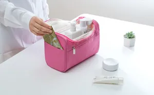 Detail view of large pink waterproof travel toiletry bag showing front pocket and interior
