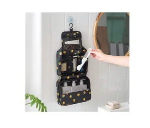 Hanging travel toiletry bag with lemon pattern showing internal storage compartments