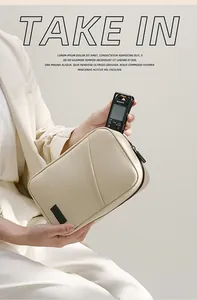 Beige PU waterproof digital storage pouch shown being used for portable electronic gear.