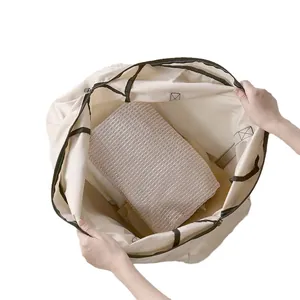 Large capacity foldable cream travel storage backpack showing interior space for clothes