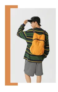 Lightweight orange foldable outdoor backpack shown on a male model from the back view