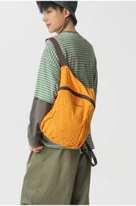 Lightweight orange grid-textured foldable outdoor backpack for hiking and travel