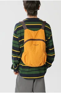 Ultra-light foldable orange checkered backpack for outdoor hiking and daily travel.