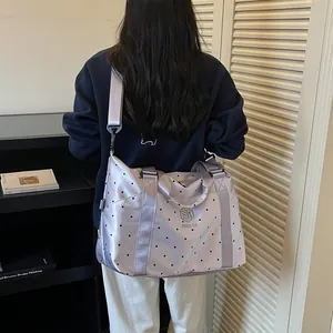 Lightweight large-capacity lavender polka dot travel bag shown on a model back view