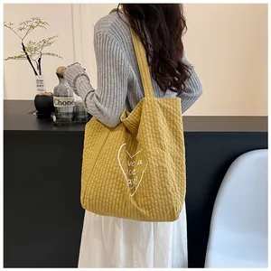 Yellow checkered canvas tote bag featuring a white heart 'Have a nice day' print.