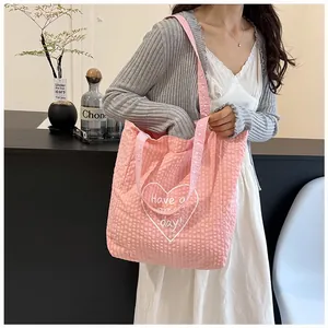 Pink textured canvas tote bag with heart print and Have a nice day slogan