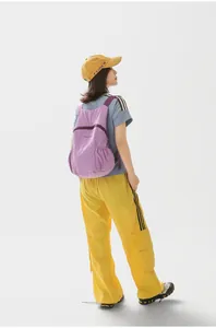 Detailed back view of a lightweight lavender foldable travel backpack on a model