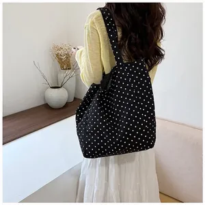 Stylish black polka dot canvas tote bag for women, large capacity for daily commute.