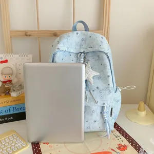 Light blue star pattern backpack shown with a laptop for size comparison