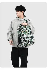 Man holding a large capacity camouflage Oxford backpack designed for travel and commuting