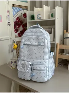 Light blue backpack with star pattern and transparent window in a study room setting