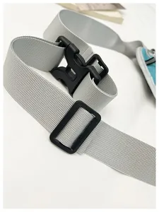 Close-up of gray nylon shoulder strap with black plastic buckle closure