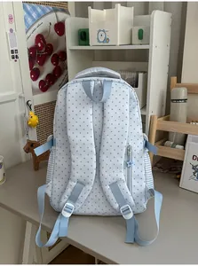Back view of light blue star-patterned student backpack featuring padded shoulder straps