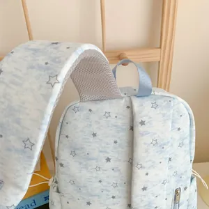 Close-up detail of light blue star pattern backpack with breathable mesh shoulder strap