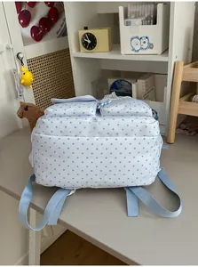 Detail view of a light blue Japanese style backpack with cute small star patterns