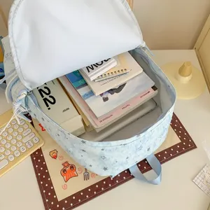 Detailed interior view of a light blue star patterned backpack filled with books and items