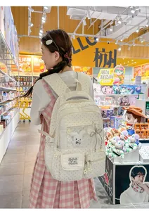 Lifestyle detail view of a Japanese style cream backpack with transparent ita-bag pocket.