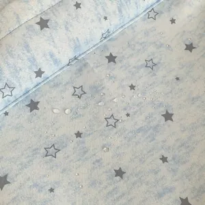 Macro detail showing waterproof texture of blue star pattern fabric for backpack
