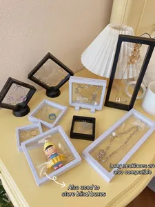 Transparent PE film floating display frames for jewelry and small collectibles on desk.