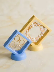 Close-up detail of macaron PE film floating jewelry display box with matching base