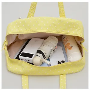 Interior detail of large capacity yellow polka dot Boston bag showing ample storage space