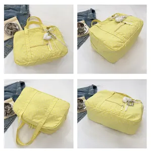 Four-view detail collage of a yellow polka dot Boston tote bag with a heart charm