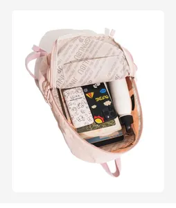 Internal view of pink travel backpack showing spacious compartment and branded lining