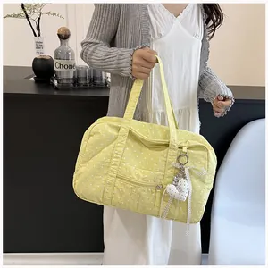 Korean style yellow polka dot Boston bag held by model for travel and commute