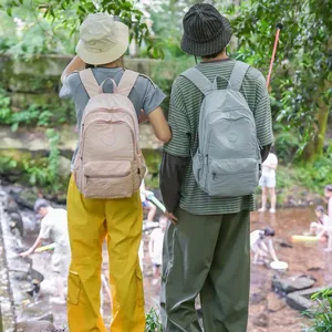 Detailed view of lightweight outdoor travel backpacks in pink and light blue colors.