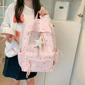 Stylish pink schoolbag featuring star patterns and a cute star plush pendant accessory