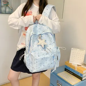 Detailed shot of a light blue star print backpack worn by an Asian female student.